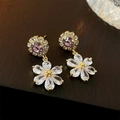 Macro detail of 18K gold plated flower earrings with purple and clear cubic zirconia - Gold Flower (With Purple Zirconia Stud)