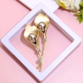 Close-up of golden calla lily brooch with pearls and rhinestones on pink background - XZ025-Calla Lily Pearl-Boxed
