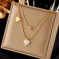 Double layered gold heart necklace featuring a shell pendant and sleek snake chain - Gold
