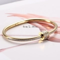 Elegant gold stainless steel bangle with sparkling crystals and 6cm inner diameter - Gold