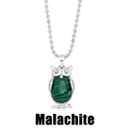 Macro detail of silver owl pendant featuring green malachite stone and beaded chain - Malachite