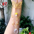 Detail of golden butterfly suncatcher with yellow mushroom and faceted crystal ball - Gold Butterfly Yellow Mushroom
