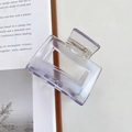 Minimalist square lavender acetate hair claw clip displayed on an open book - 5.2cm / Clear