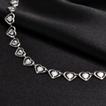 Macro shot of silver hollow heart chain links with radial texture on black silk fabric - Silver Necklace