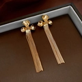 Detail view of gold-plated flower stud earrings with long sleek snake chain tassels - Real Gold Plated Silver Pin Style / Gold