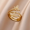 Macro shot of gold butterfly ring with cubic zirconia stones on soft beige silk - Gold Butterfly Wrap (G3014454)