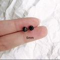 5mm black zircon stud earring with 925 silver needle shown on a fingertip for scale - 5mm Black Zircon 1 Pair