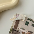 Detailed macro view of a white pearlescent kitten hair clip with a purple ribbon bow - Off-white