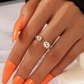 Minimalist silver open ring with teardrop design shown on model hand against marble - Silver