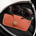 Orange lychee grain leather glasses case with golden flower buckle and metal spring hook - Hermes Orange
