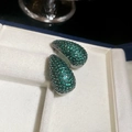 Macro shot of silver stud earrings with vibrant green teardrop emerald zircon inlay - Teardrop Shape - Green - Silver Base