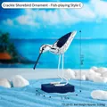 Mediterranean wood shorebird decor with black cracks on blue base for beach home - Cracked Seagull Ornament-Playing with Fish (7311B-03)