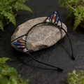 Macro shot of handmade cat ear headband with colorful crystals on a natural stone base - Dark Blue Cat Ears