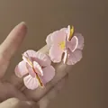 Detail of pink flower stud earrings with enamel petals and gold edges held in hand - 36# Silver Needle - Pink