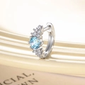 Silver hoop earring featuring a round light blue zircon and small clear crystals - Light Sea Blue