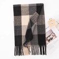 Plaid scarf in black, grey, and beige with fringe, styled with lifestyle accessories - Black Check