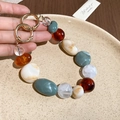 Detailed view of handmade vintage acrylic beaded phone chain with gold metal rings - Phone Chain / Green/Coffee/White