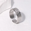 Anillo ajustable de acero de titanio plateado con cara sonriente sobre fondo de piedra - Ajustable / Color Acero