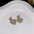 Golden heart earrings with white cubic zirconia pavé on a white ceramic plate - E4315-925 Sterling Silver Earring Post / Gold White Zirconia