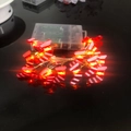 Festive red candy cane LED string lights with battery box on a glossy black background - 1m 10-LED (2AA Battery Model) / Red and White Enamel Christmas Sock