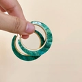 Close-up of bohemian green marble acrylic hoop earring with gold rim held by hand - Silver Pin Hoop Gold-Green / Gold-Green