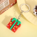 Cartoon red Christmas gift box keychain with green ribbon and star on yellow background - Gift Box (Silver Keychain)