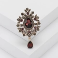 Vintage red teardrop pendant brooch with crystals on a white geometric platform - Purple