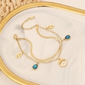 Detailaufnahme eines doppellagigen goldenen Edelstahlarmbands mit Evil Eye und Anhängern - Doppellagiger Tropfen Zirkonia Stil (6#)