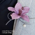 Eleganter violetter Samtblumen-Anstecker mit Kristall und Perle auf einem grauen Sakko - Flieder