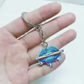 Creative acrylic keychain featuring a blue lip biting a pencil on a metal keyring - Pencil Lip Keychain