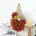 Detail of autumn gnome wall decor with burlap hat, sunflower, and red maple leaves - Red with Black Pattern / No Light Version