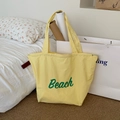 Gelbe Nylon-Tragetasche mit grünem Beach-Aufdruck und Kordelzug für den Sommer - Gelb mit Beach-Print