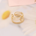 Detail of gold multi-layer ring with star and bead accents on soft fabric - Star & Bead Layered Design (10#)