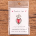 Red enamel pocket hug heart pendant on English sentiment card with wooden background - Simple Silver Edge Heart
