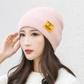 Pink knit beanie with yellow letter label for winter warmth and casual style - Pink
