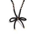 Classic necklace with black faceted beads, gold accents and a bow pendant on white base - Black (N3260)