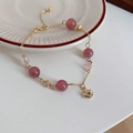 Detailed macro of golden chain bracelet featuring pink crystal beads and heart pendant - 14# Gold Strawberry Quartz Bracelet