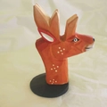 Handcrafted deer wood carving glasses holder in orange with white spots on a black base - Elk