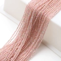 Macro shot of 2mm light pink faceted glass beads with AB coating for DIY jewelry - Pink String Pink Green