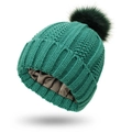 Detailed view of dark green knit beanie with soft silk lining to protect hair textures - Green