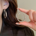 Detailed view of large silver oval hoop earrings showing high-polish metallic texture - Silver Hoop (54#)