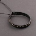 Men's punk black leather bracelet featuring bronze metal studs on a dark background - Bronze