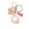 Pink resin alphabet Q keychain with gold butterfly charm and leather tassel detail - Letter Q