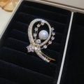 Dettaglio della spilla a farfalla placcata in oro 14k con perla bianca e zirconi lucenti - Stile Geometrico a Spirale - Oro (10#)