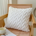Minimalist white faux rabbit fur pillow with chunky cable knit texture on a wooden chair - Plush Bubble Small Leaves