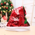 Close-up of reversible red and green sequins on Christmas hat with white plush trim - Red Flipping Green