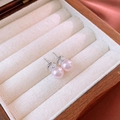 Close-up of pink round pearl stud earrings with silver needles on a velvet jewelry box - Pink Pearl Studs (8mm)