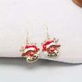 Christmas reindeer drop earrings with red enamel hats and golden hooks on white fabric - Deer Head Earrings