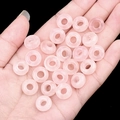 Handheld view of pink semi-transparent natural stone beads with a large 5mm hole - 6x12mm Rose Quartz (Single)