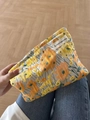 Floral pattern yellow canvas cosmetic bag held by model for travel storage - Orange Pumpkin Flower